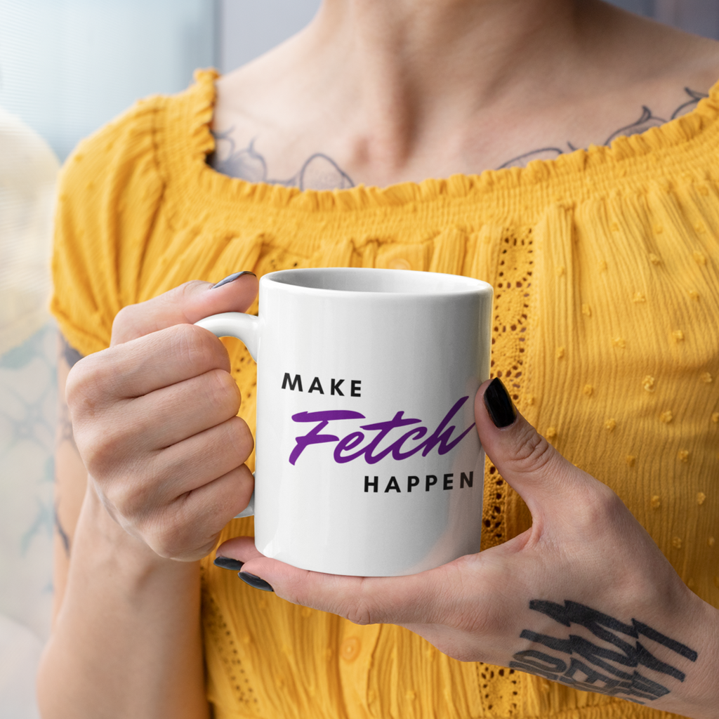 Woman holding white mug w/ Make Fetch Happen design