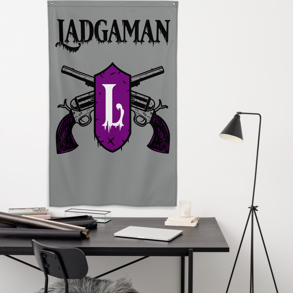 a desk with a lamp and the ladgaman logo flag hanging behind the desk