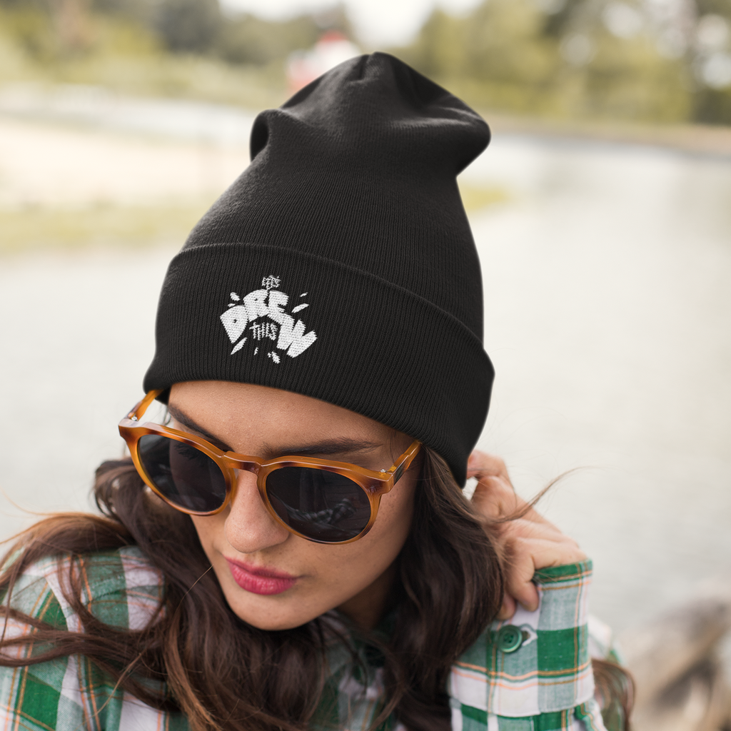 a woman wearing a black beanie with the LetsDrewThis design embroidered on the front