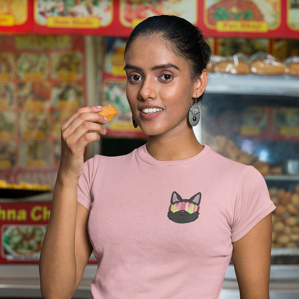 a woman eating street food, wearing a pink tshirt with the sunglasses hank design from kevin saxby