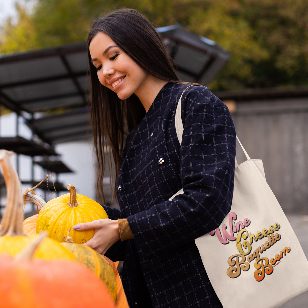 Woman picking out pumpkins with the Wine Cheese Baguette Boom tote over her shoulder