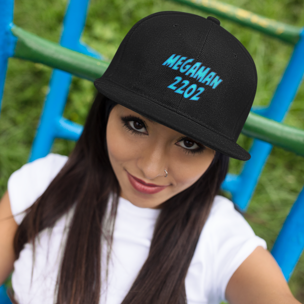 a woman at a playground wearing a black snapback hat with the megaman2202 wordmark embroidered