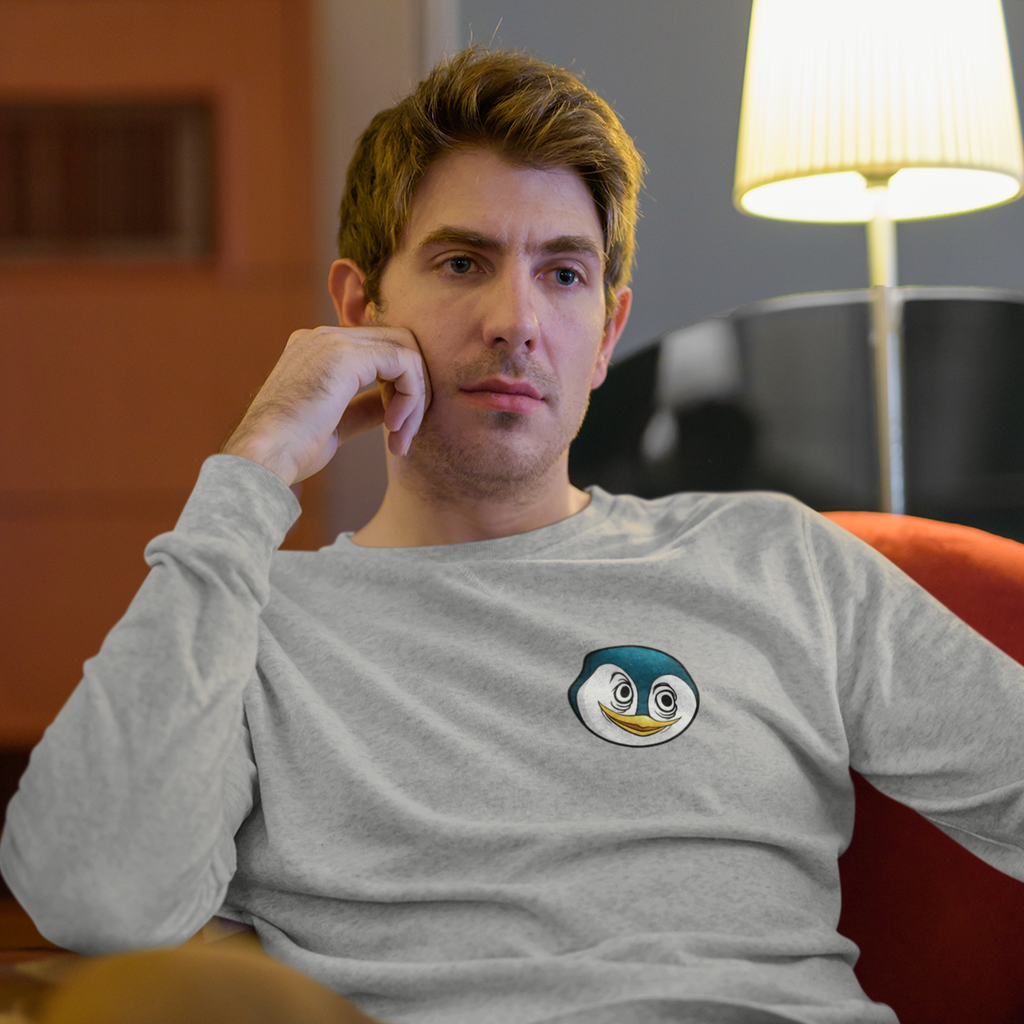 a man sitting on a recliner wearing a heather grey long sleeve shirt with the F333tzSuffer icon on the front
