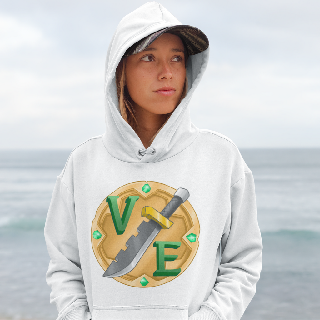 a woman standing on the beach wearing a white hoodie with the VoicesExtremeus logo on it