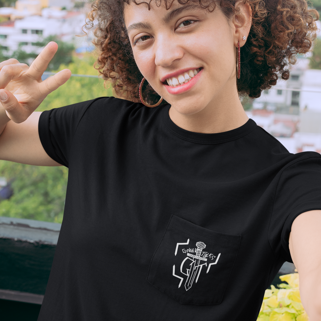 a woman wearing a black pocket tshirt with the ginger talks logo on it