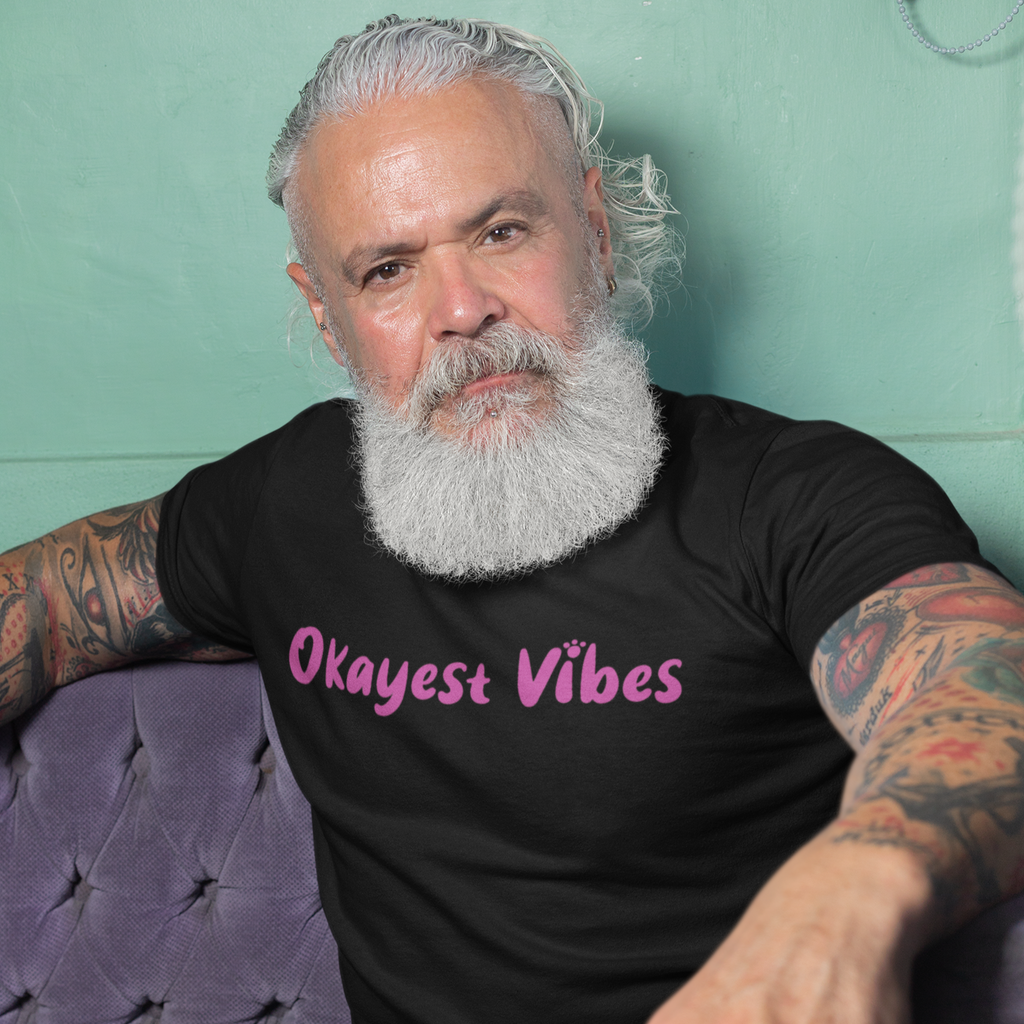 Man with tattoos wearing a black shirt with the okayest vibes design.