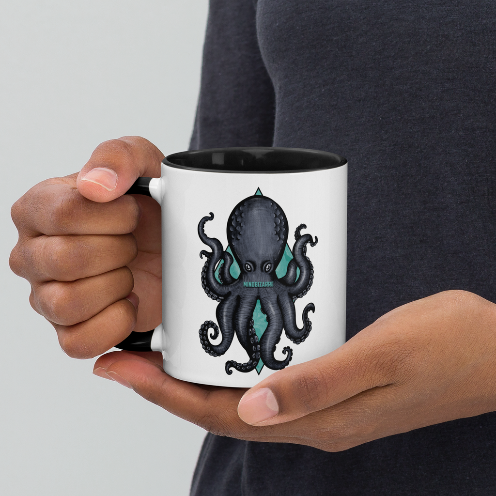 Person holding black/white mug with Octopus design