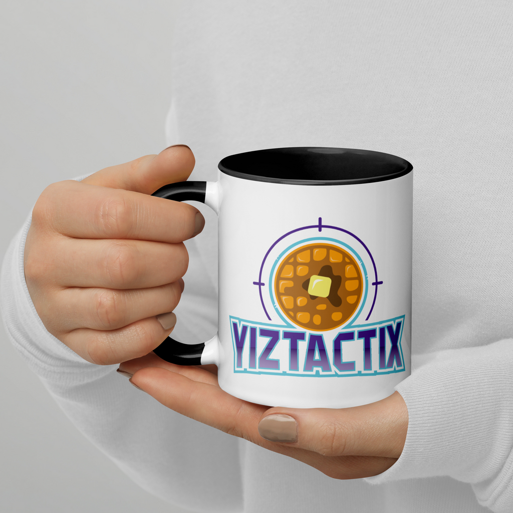 Person holding white and black mug with Yiztactix logo