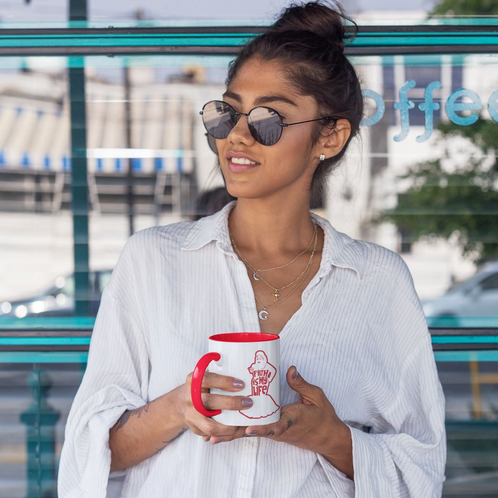 woman holding red and white mug with divine logo