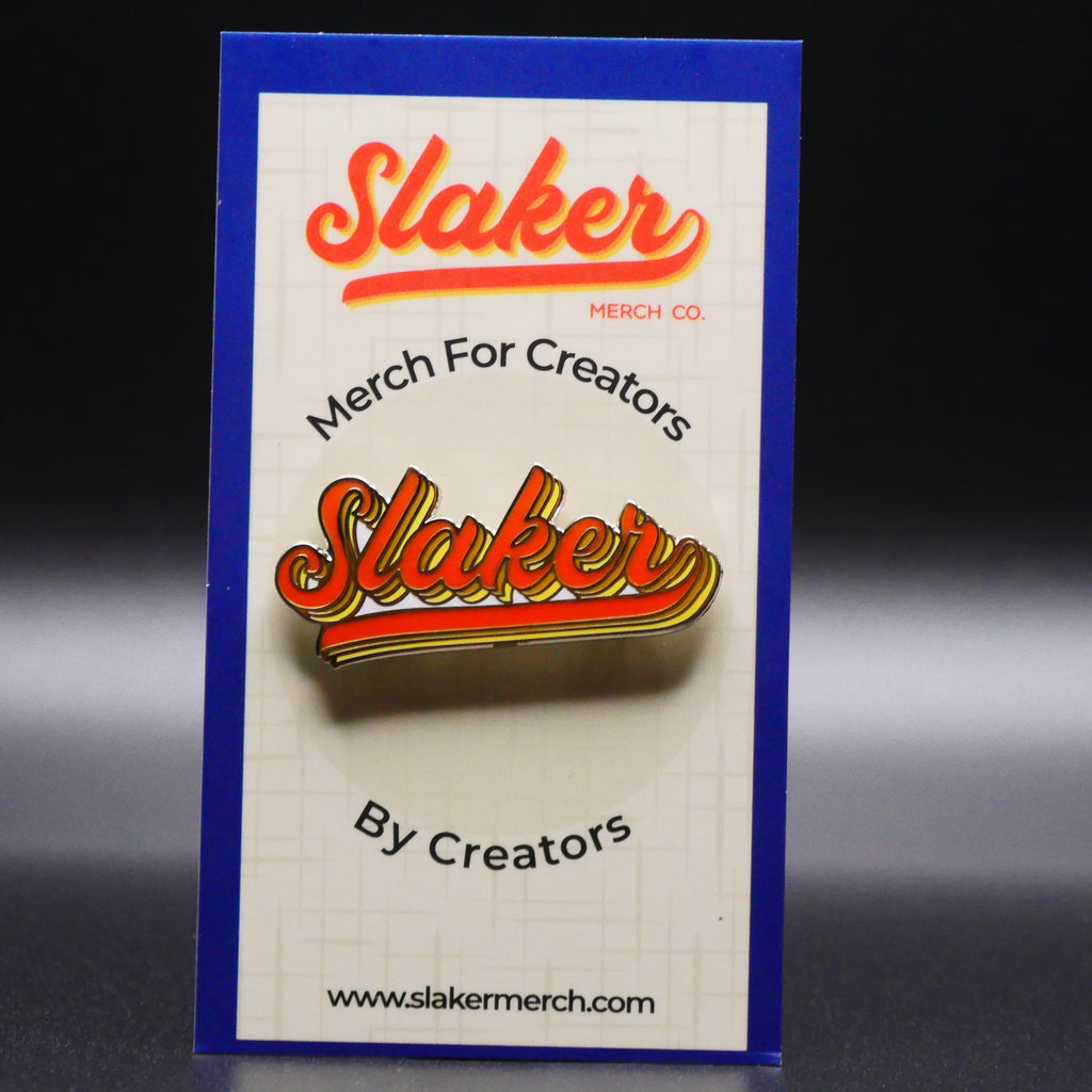The slaker merch wordmark as a hard enamel pin on the slaker merch backer card.