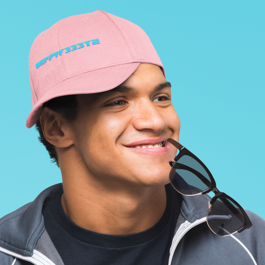 A man with sunglasses in his mouth wearing a pink dad hat with the happyf333tz word mark embroidered