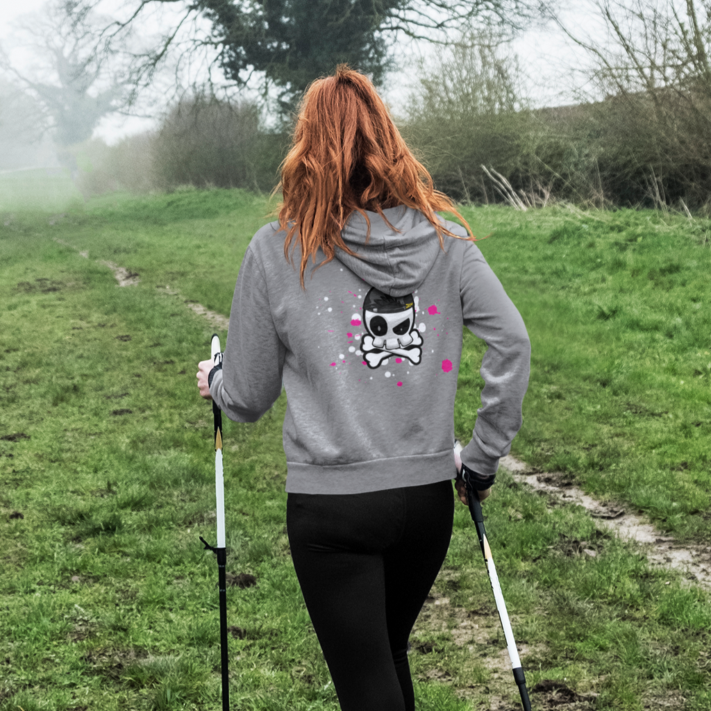 a woman hiking and wearing an athletic heather zip hoodie with the skull splat design from slamdannigan