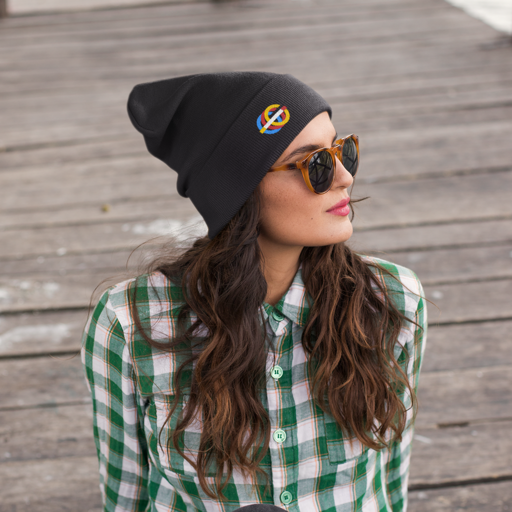 a woman sitting on a deck wearing a black beanie with the gosfather retro logo embroidered on it