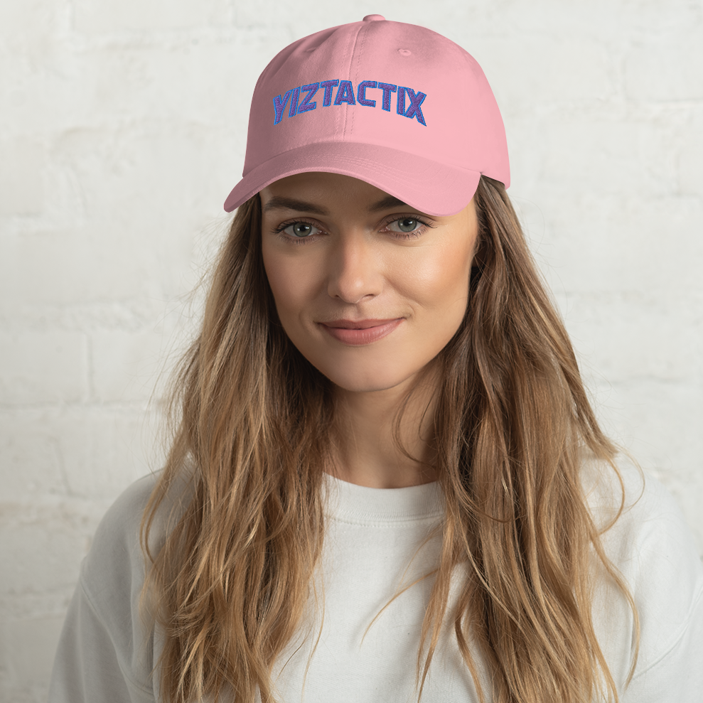 Woman wearing pink dad hat with Yiztactix wordmark design