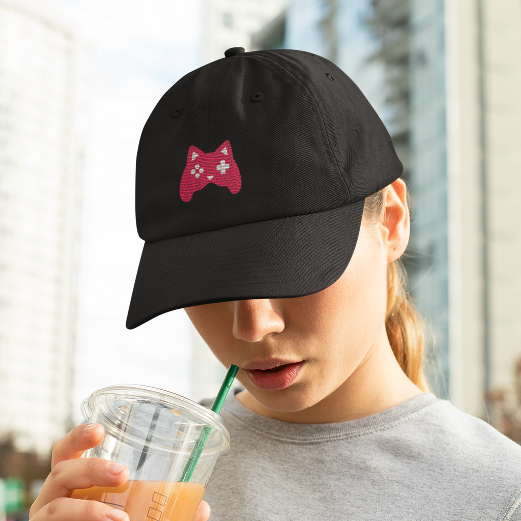 Woman wearing a dad cap and drinking an iced coffee