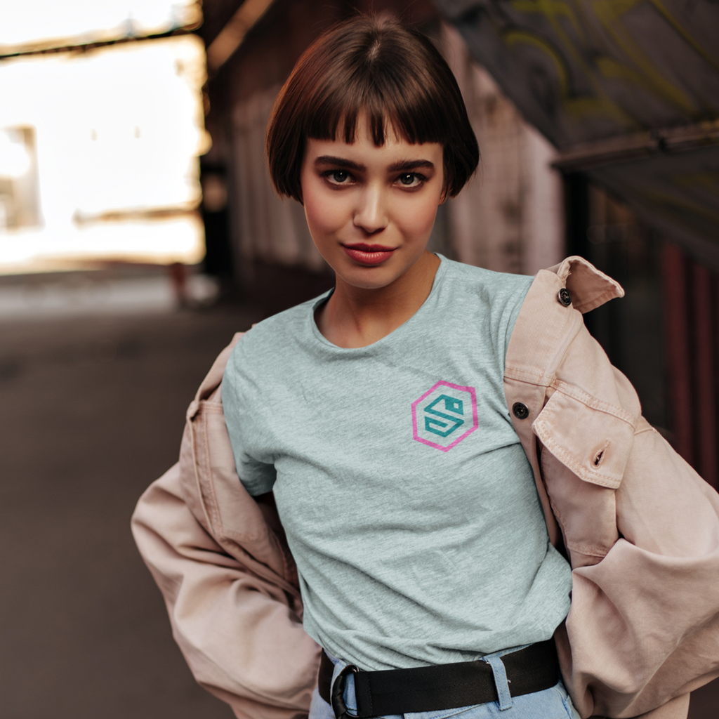 a woman wearing a pink jean jacket and a heather prism ice blue tshirt with the serpentzn logo on the chest