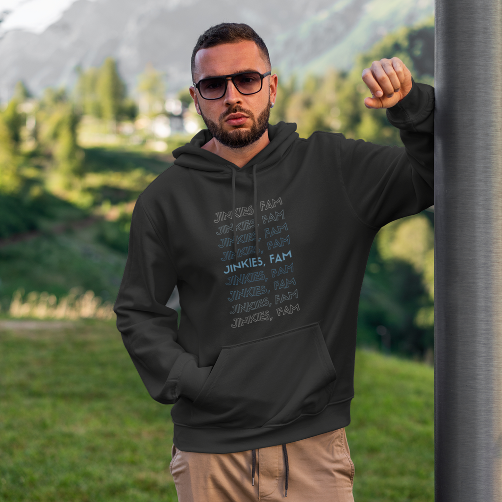 A man leaning against a pole wearing a black hoodie with the Jinkies Fam design from aBlackSparrow