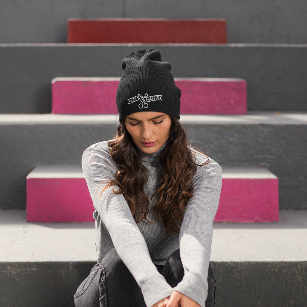 woman with long hair wearing a black beanie with the megggg croprafter design