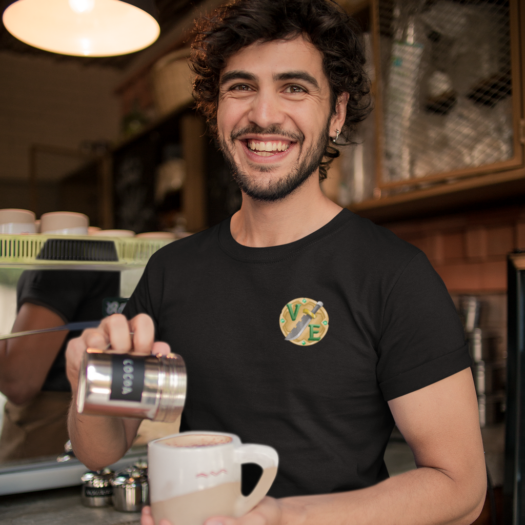 a man pouring a cup of coffee wearing a black tshirt with the small voicesextremeus logo