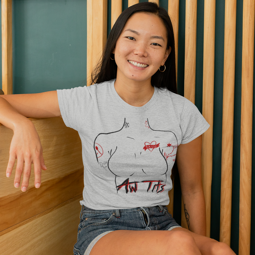 a woman sitting down wearing a athletic heather tshirt with the aww tits design from gingersnaps67