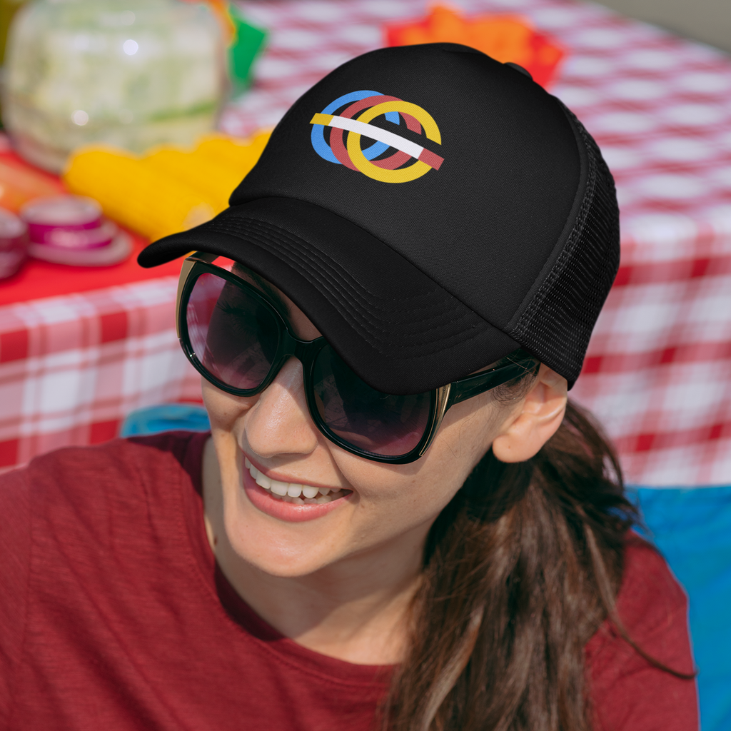 A woman at a picknick wearing a black trucker hat with the Gosfather80 retro logo embroidered