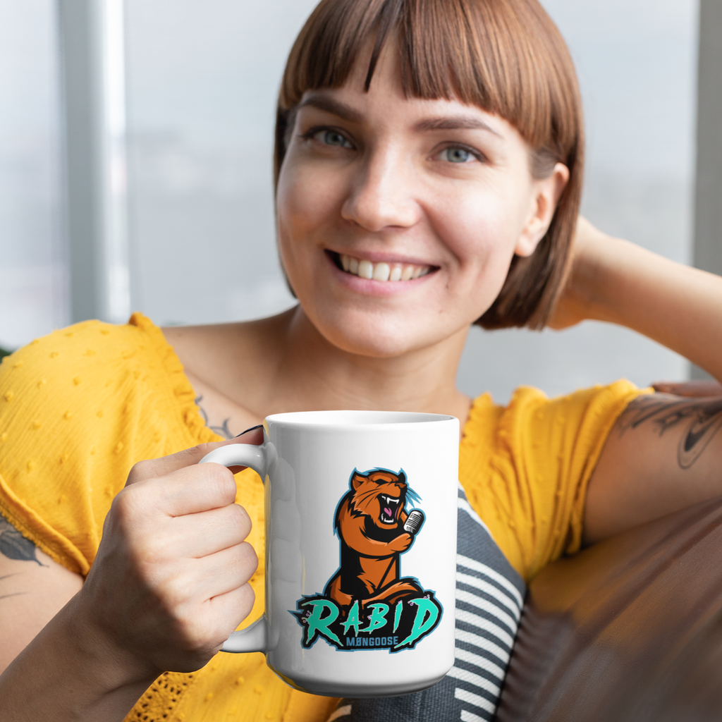 Woman sitting on a couch holding a coffee mug with the RabidM0ngoose logo on it.