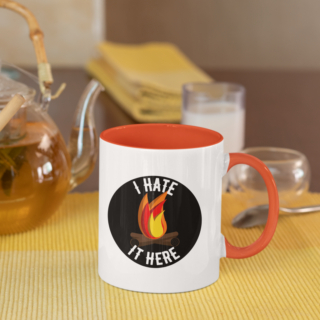 mug with orange handle and orange inside with the I hate it here design on it