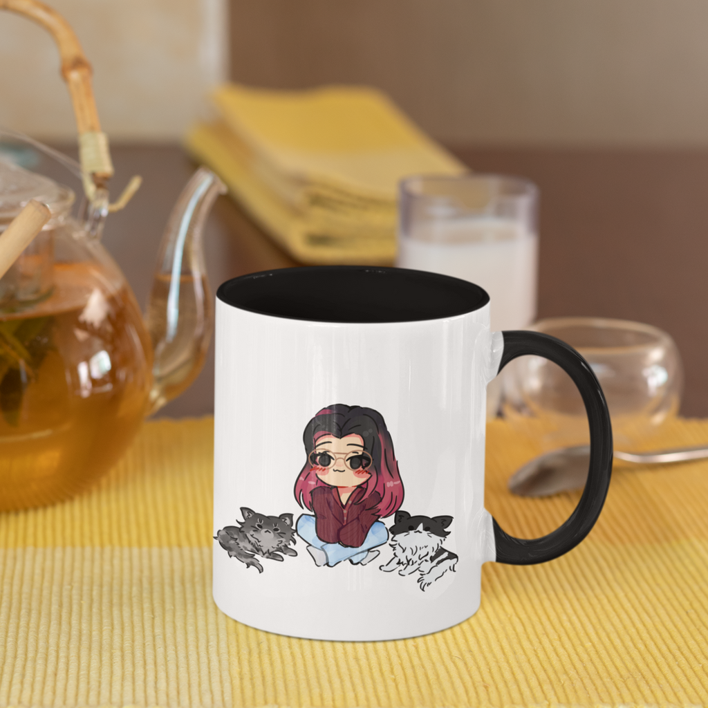 a mug with a black rim and black handle and the megg cats design from OhhMeggs