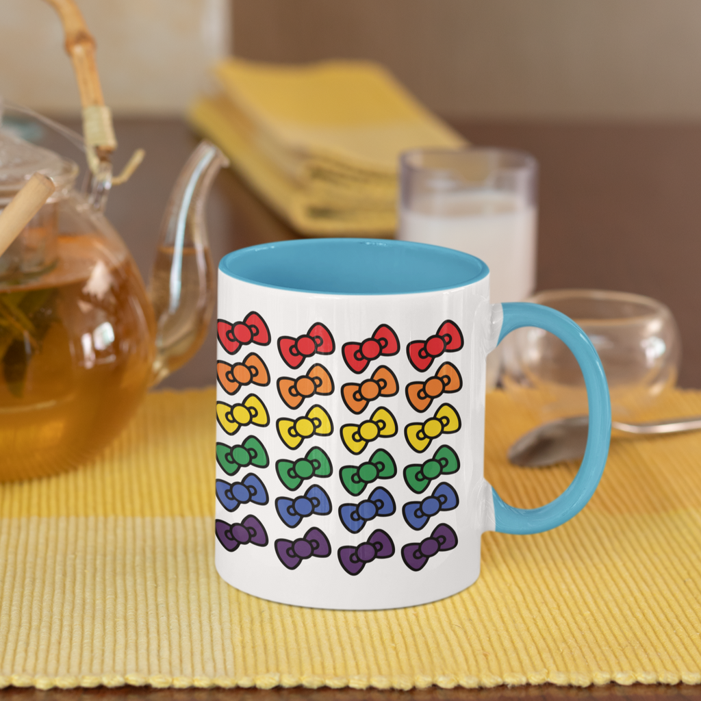mug with blue handle and blue inside and the megggg rainbows design on the outside