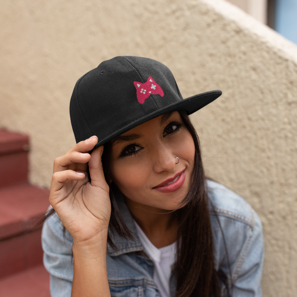 A woman sitting on stairs with a black EJSturk catroller snapback hat.