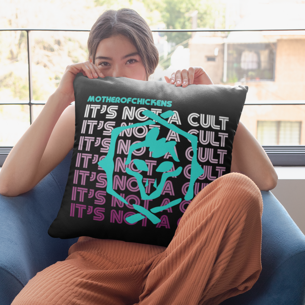 a woman holding a black pillow with the "It's Not A Cult" design from Mother0fChickens