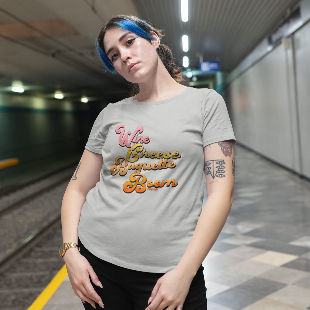 woman in a subway station wearing a grey tshirt with the wine cheese baguette boom design