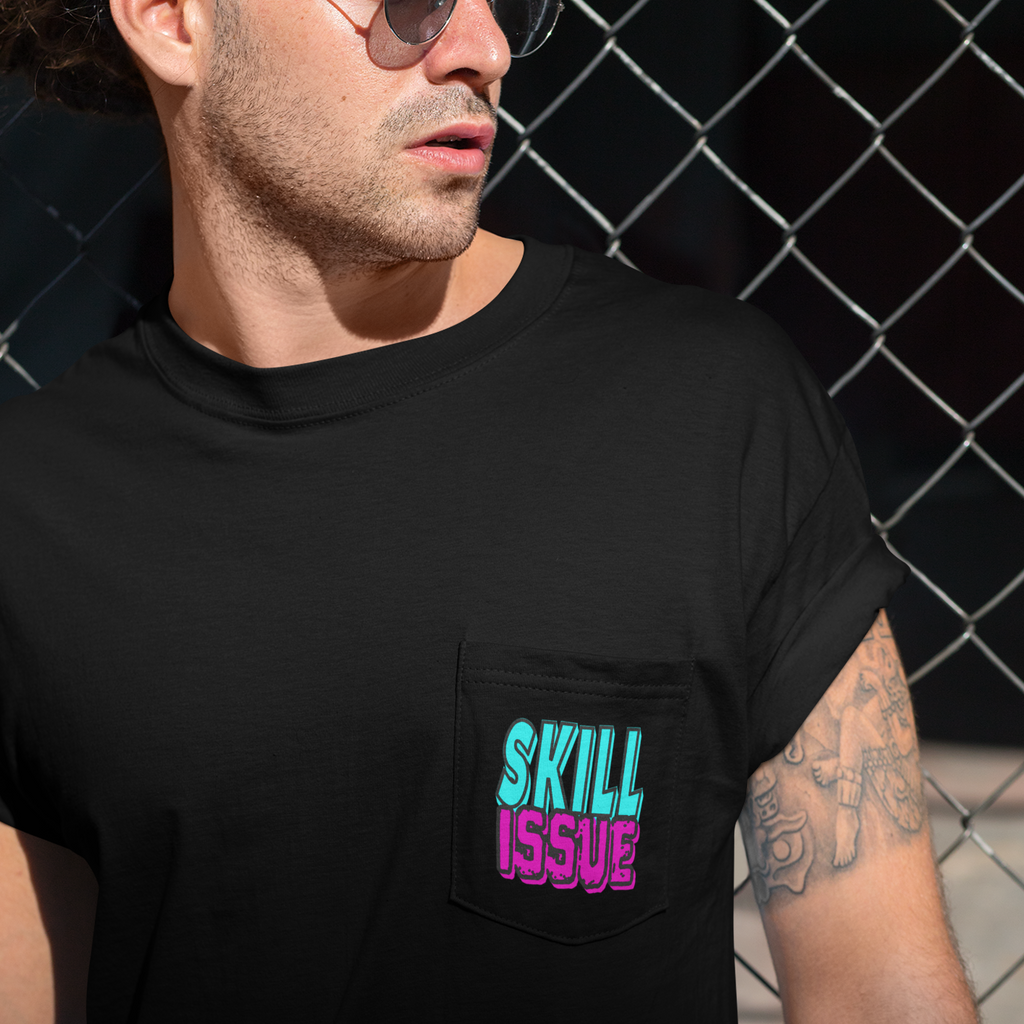 a man standing in front of a fence with a black pocket tshirt and the skill issue design from Mother0fChickens