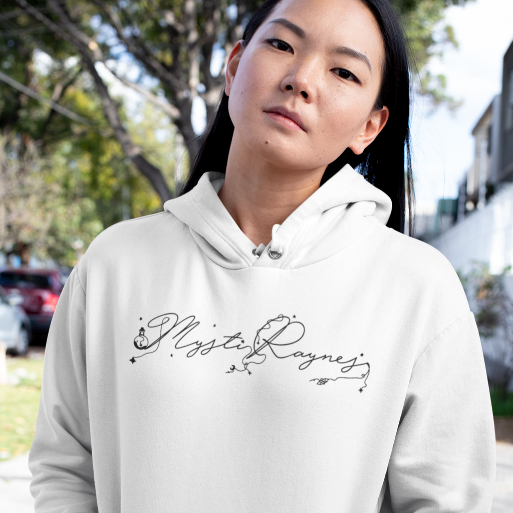 Woman wearing a white hoodie with the mysti raynes logo