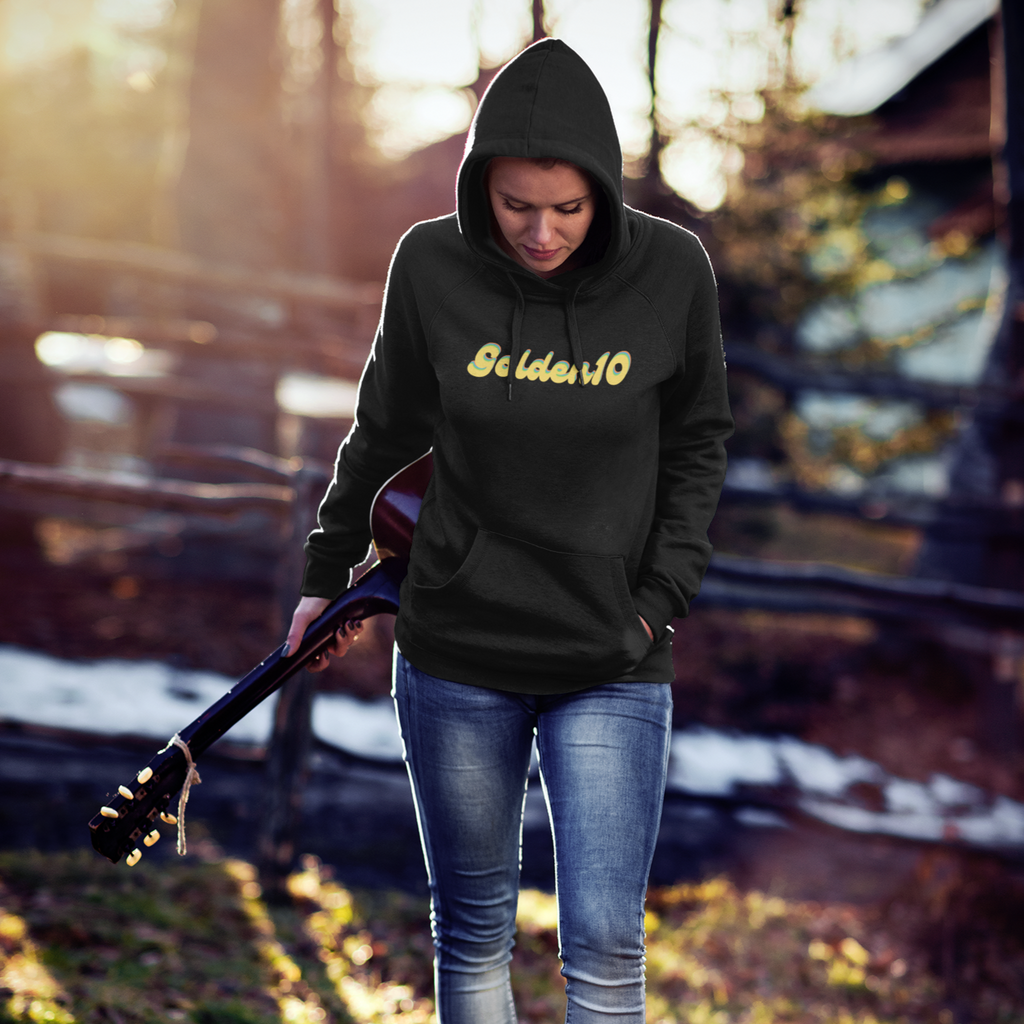 A woman holding a guitar and wearing a black golden10 hoodie from Gingersnaps67