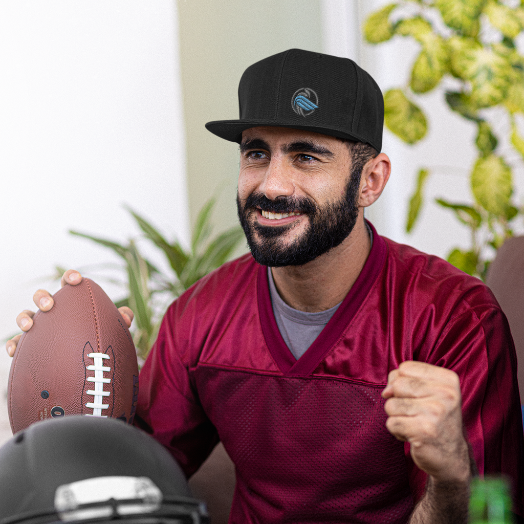 A man holding a football wearing a black snapback hat with the sparrow coin embroidered from aBlackSparrow