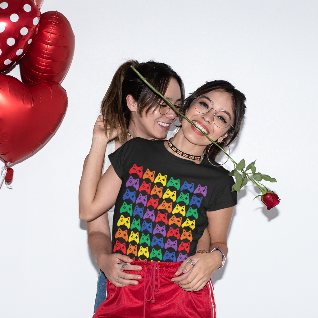 two women embracing, one wearing a black tshirt with the catroller rainbow design from EJSturk