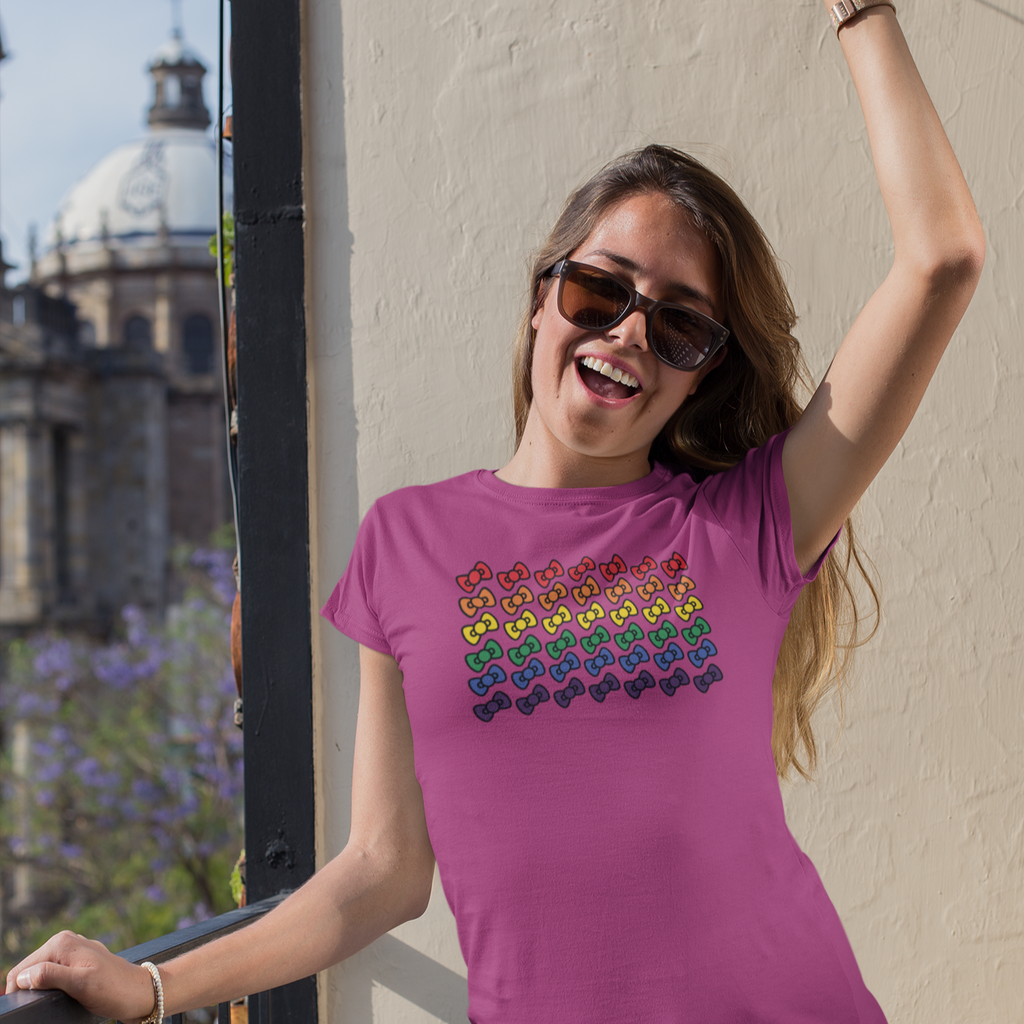 Woman wearing sunglasses and a pink shirt with the megggg rainbow design