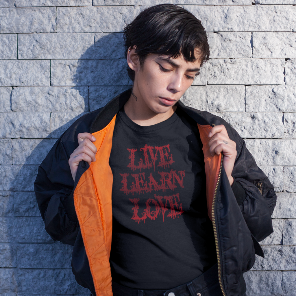 Woman wearing a bomber jacket and a black shirt with the poisoned heart live learn love design.