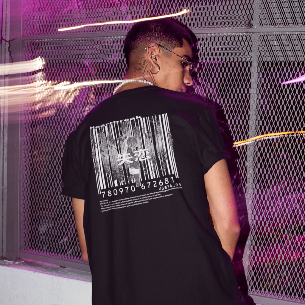 a man with glasses standing facing away with the heardbreak design on a black tshirt from Falsepeak_