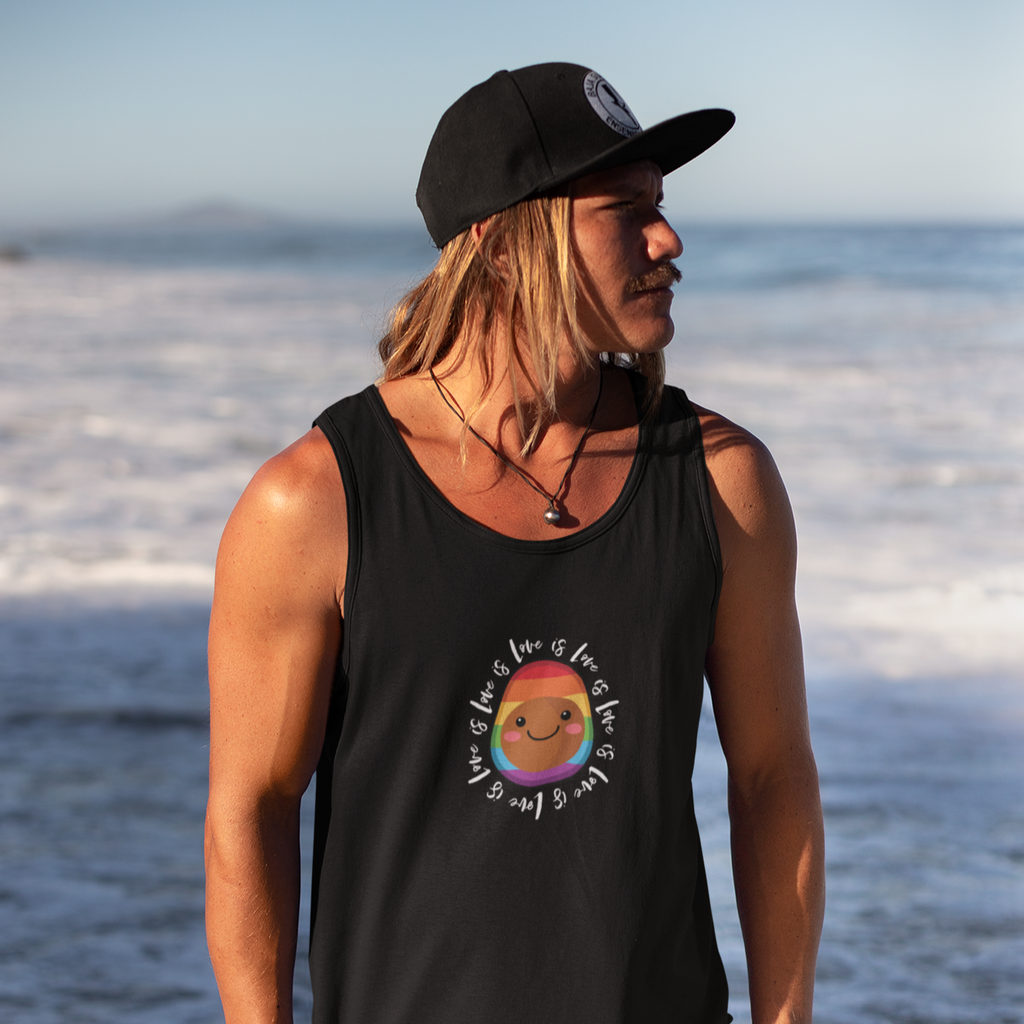 Man at beach wearing a hat.  He's wearing a black tanktop with the pascal love is love design on it.