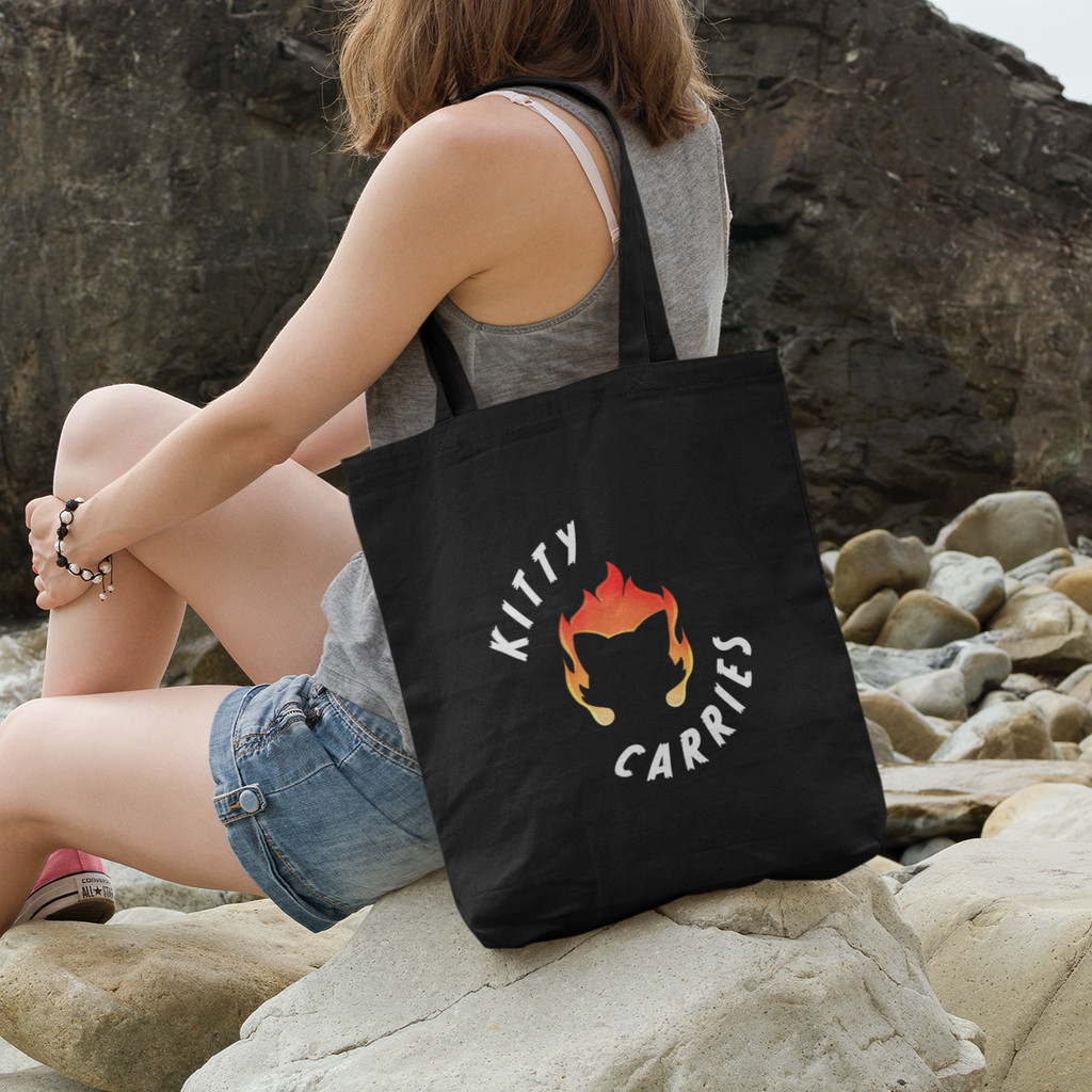 Woman carrying tote bag with Kitty Carries design