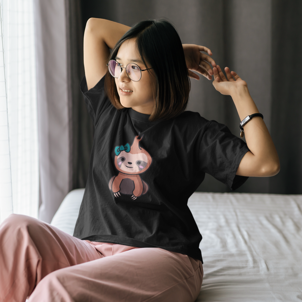 Woman stretching on her bed wearing a black tshirt with the megggg fred design on it