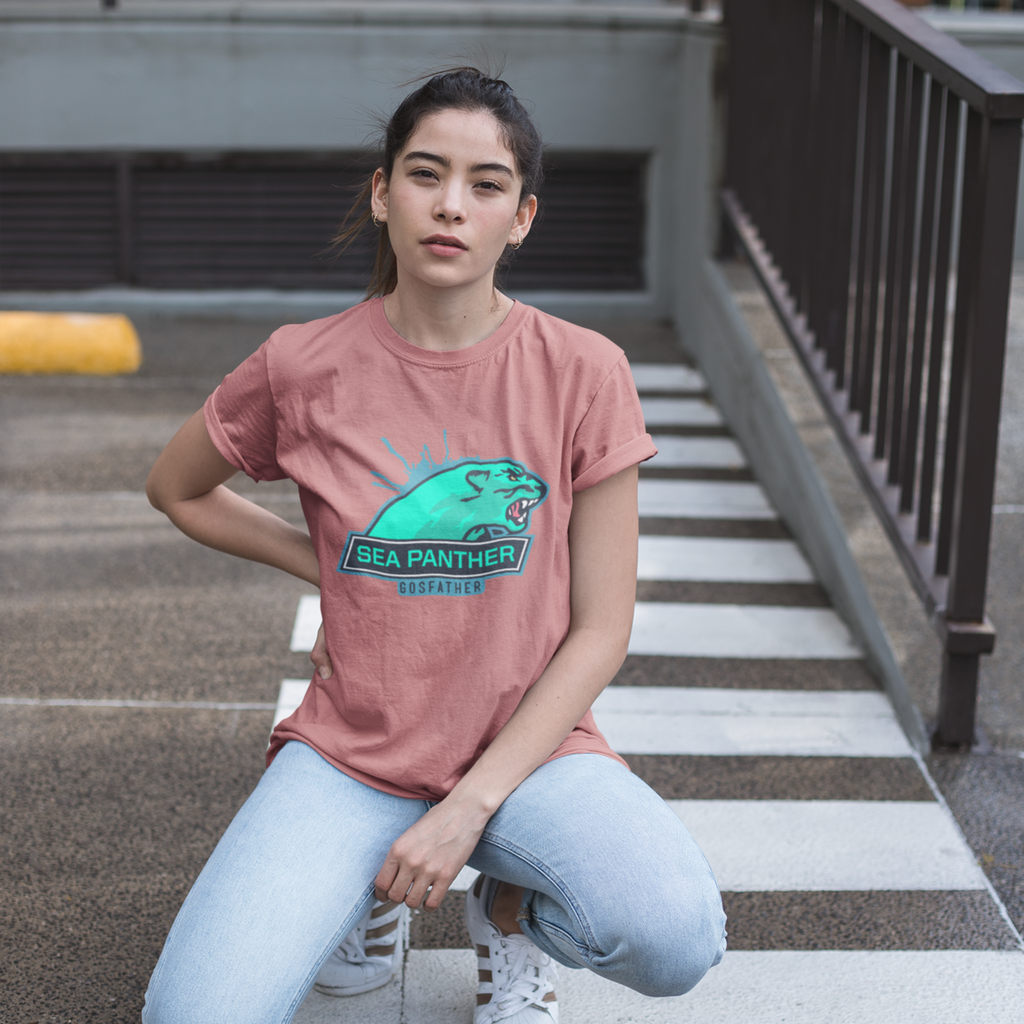 a woman kneeling in a parking lot wearing a mauve tshirt with the sea panther design from gosfather