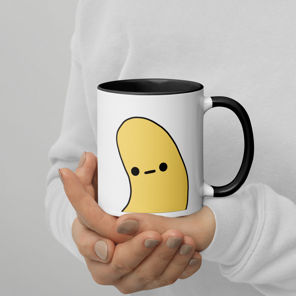 Person holding black/white mug with Banana Pop design