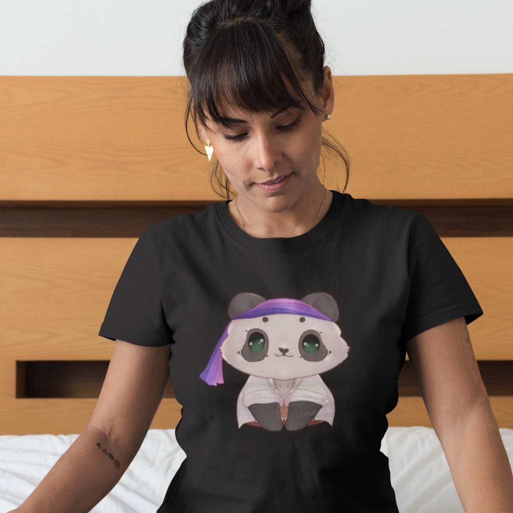 Woman sitting on a bed wearing a black tshirt with the Bruff_Lingel Birate Panda design